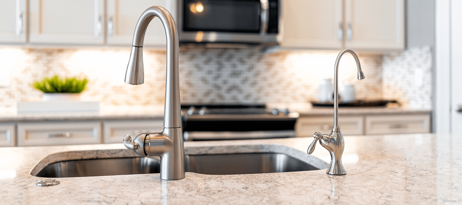 A modern kitchen sink with a high-arc faucet and a separate filtered water tap